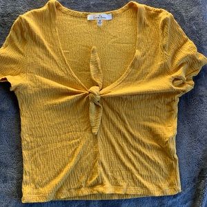 Mustard yellow crop top with a v-neckline